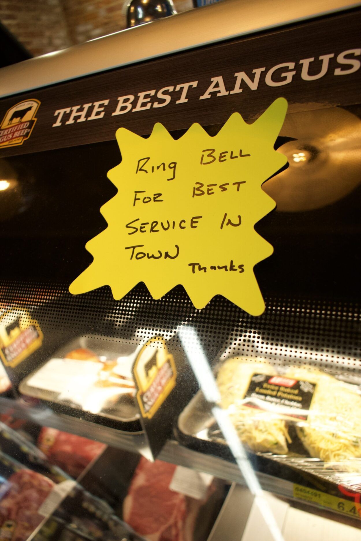 "ring bell for best service in town" sign at the butcher counter