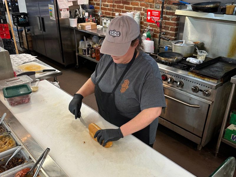 Employee working at South Point Grocery's deli.